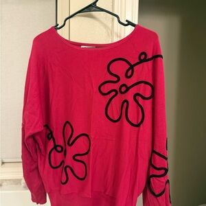 Stylish Pink Sweater with Black Floral Design